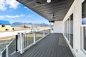 Covered deck with a great view of the mountains and view of large yard!