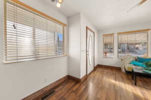 Entrance foyer featuring ceiling fan and dark hardwood / wood-style flooring