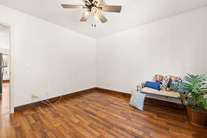 Unfurnished room featuring dark hardwood / wood-style floors and ceiling fan