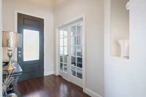 Entrance foyer featuring dark wood-type flooring