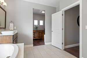 Bathroom featuring vanity, a bathtub, and a textured ceiling