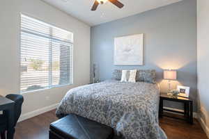 Bedroom with ceiling fan and dark hardwood / wood-style flooring