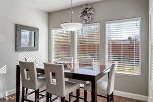 Dining room with hardwood / wood-style flooring and a healthy amount of sunlight