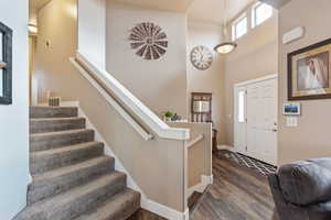 Entrance foyer featuring a high ceiling and dark hardwood / wood-style floors