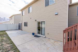 Rear view of house featuring a mountain view and a patio area