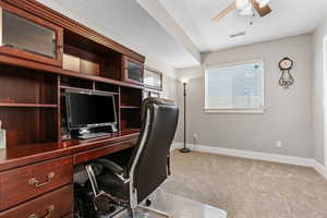 Carpeted office with ceiling fan