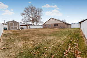 View of yard with a storage unit