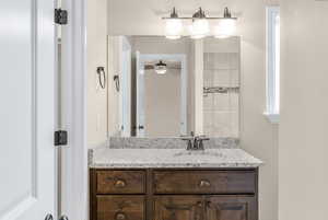 Bathroom with ceiling fan and vanity