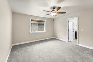 Carpeted spare room with ceiling fan and a textured ceiling