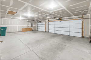 Garage with electric panel and a garage door opener