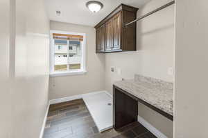 Laundry area with cabinets and hookup for a washing machine