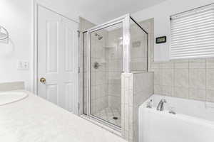 Bathroom featuring plus walk in shower and vanity