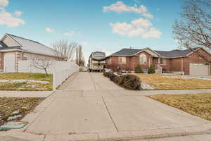 View of front of house with a front lawn and a garage