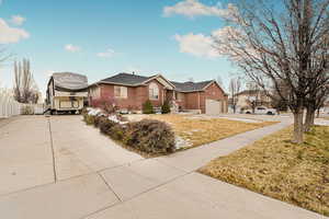 Single story home with a front lawn and a garage