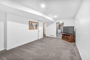 Unfurnished living room featuring carpet floors