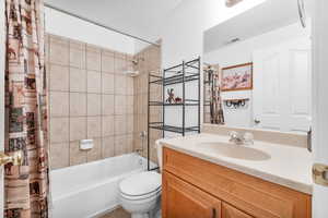 Full bathroom with vanity, toilet, and shower / tub combo