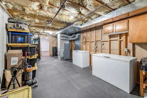 Basement with heating unit and fridge