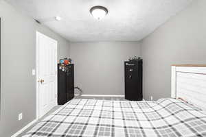 Unfurnished bedroom with carpet and a textured ceiling