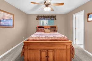 Carpeted bedroom with ceiling fan