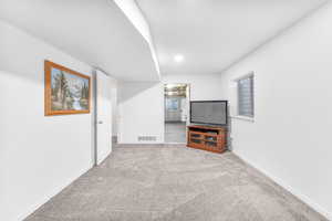 Unfurnished living room featuring carpet