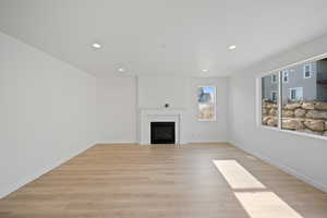 Unfurnished living room with light hardwood / wood-style floors