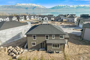 Back of property featuring a water and mountain view