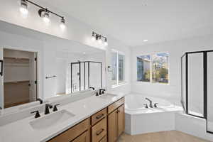 Bathroom with tile patterned floors, vanity, and independent shower and bath