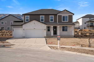 View of front of house featuring a mountain view and a garage