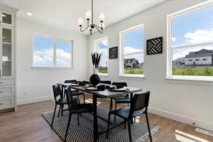 Dining area with a chandelier and light hardwood / wood-style floors