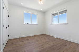 Spare room with a wealth of natural light and hardwood / wood-style flooring