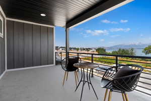 Balcony featuring a water and mountain view