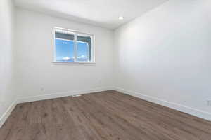 Unfurnished room with dark hardwood / wood-style flooring