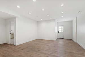 Empty room with sink and light wood-type flooring