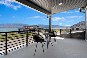 Balcony with a water and mountain view