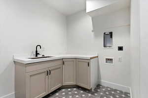 Laundry area featuring hookup for a washing machine, sink, cabinets, and hookup for an electric dryer