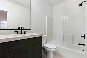 Full bathroom featuring shower / tub combination, vanity, toilet, and tile patterned floors