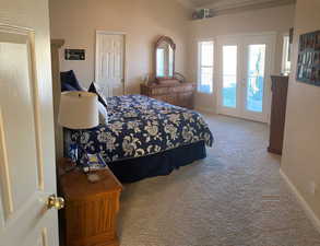 Carpeted bedroom with access to outside and french doors