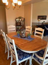 Dining area featuring hardwood flooring and a notable chandelier