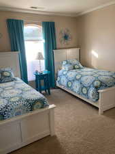 Bedroom with carpet flooring and crown molding