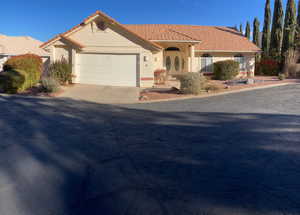 Mediterranean / spanish-style home with a garage