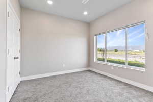 Empty room with a mountain view and carpet floors