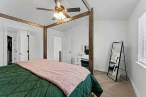 Bedroom featuring ceiling fan, multiple windows, light carpet, and vaulted ceiling