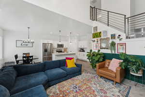 Living room featuring a high ceiling and a chandelier