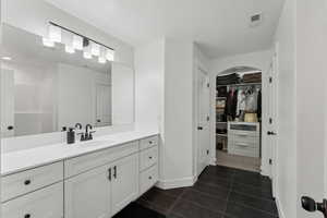 Bathroom with tile patterned flooring and vanity