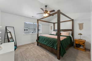 Bedroom with ceiling fan and light colored carpet