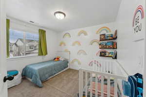 Bedroom with light carpet and a textured ceiling