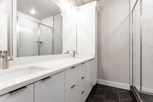 Bathroom featuring vanity and an enclosed shower