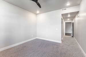 Carpeted empty room with ceiling fan