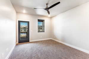 Empty room with carpet and ceiling fan