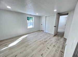 Unfurnished master bedroom featuring LVP flooring. Photo taken after renovation before owners moved in.